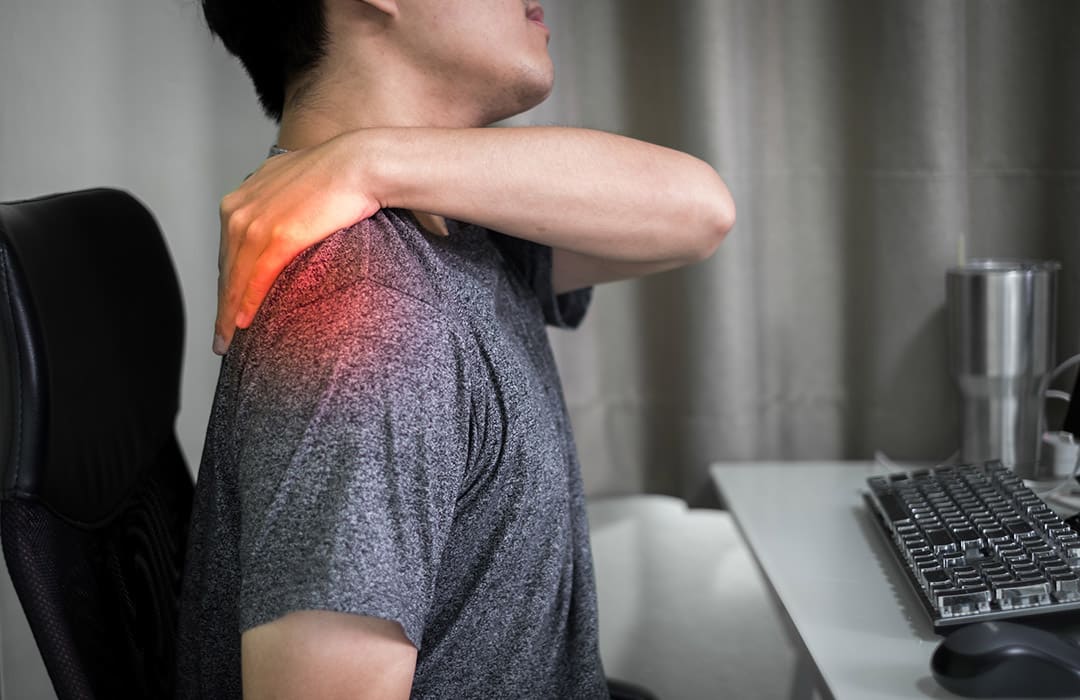 Personne se massant les épaules pour soulager des tensions musculaires